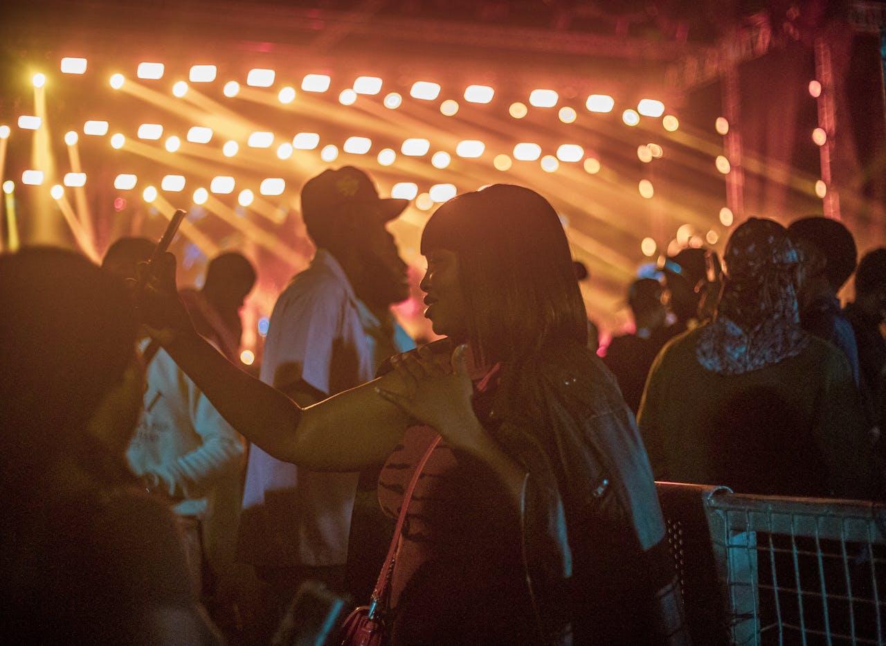 Energetic crowd enjoying a lively night event with vibrant lighting displays.